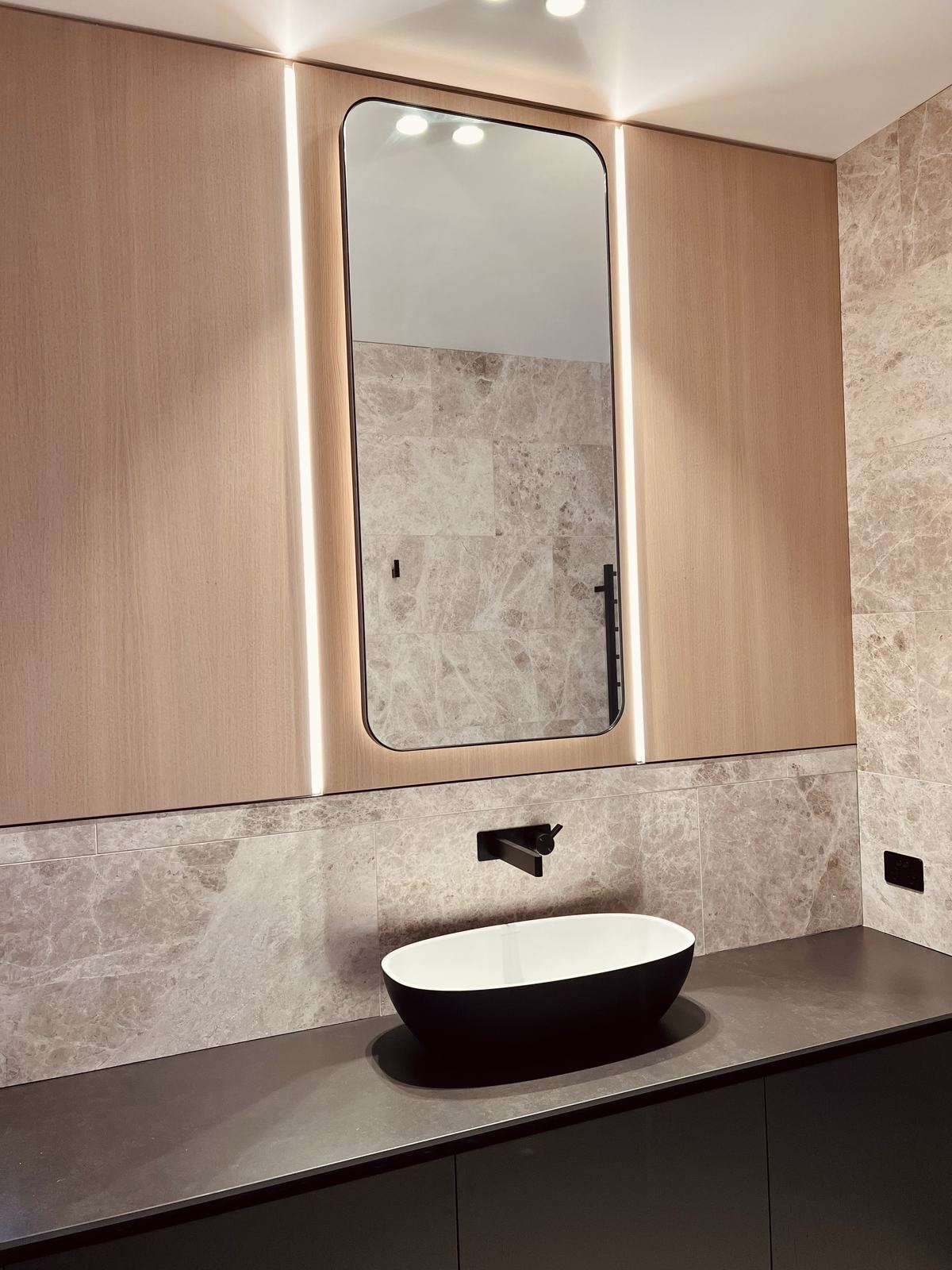 LED-lit bathroom mirror installation