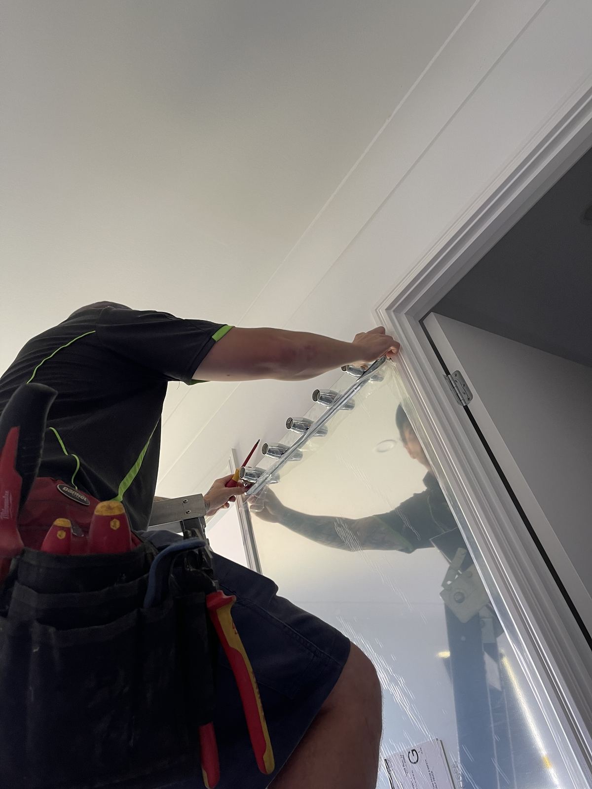 Electrician wiring a switchboard on site